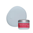 A jar of Colourtrend sample paint with a red label and silver lid, shown in front of a large oval swatch of the pale icy blue-grey product on a white background. connecticut colout